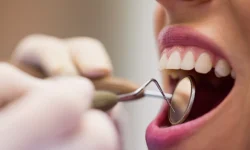 dentist-examining-female-patient-with-tools_107420-65429