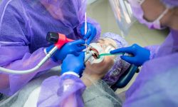 dentist-his-assistant-perform-operation-office-install-dental-implant_359031-21236 dentist-his-assistant-perform-operation-office-install-dental-implant_359031-21236